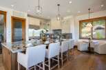 Experience luxury in this stunning kitchen, featuring a large marble island with seating, perfect for entertaining.