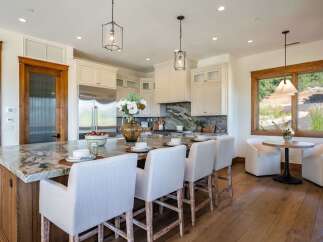 Experience luxury in this stunning kitchen, featuring a large marble island with seating, perfect for entertaining.