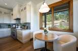 Experience modern living in this stunning kitchen, featuring sleek white cabinetry, marble countertops, and a professional-grade gas range.