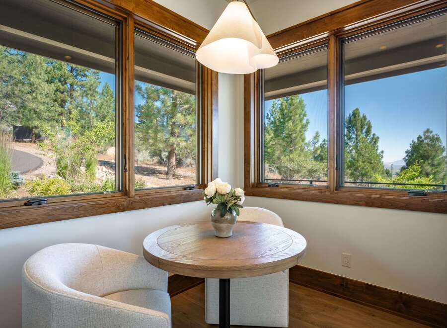 Enjoy your morning coffee in this charming breakfast nook, bathed in natural light from expansive windows.