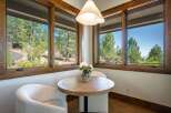 Enjoy your morning coffee in this charming breakfast nook, bathed in natural light from expansive windows.