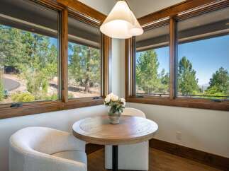 Enjoy your morning coffee in this charming breakfast nook, bathed in natural light from expansive windows.