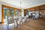 Experience luxurious open-concept living with this stunning dining and living area, featuring expansive sliding glass doors that open to breathtaking natural views.