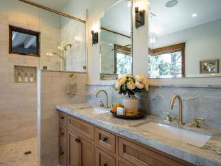 Experience luxury in this stunning master bathroom, featuring a spacious walk-in shower with elegant tilework and a convenient niche for toiletries.