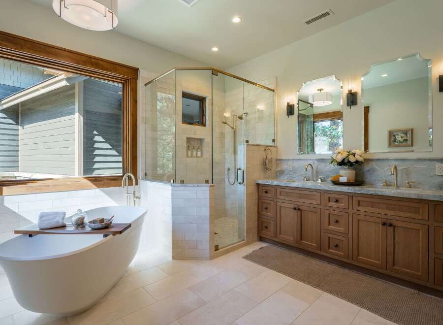 Experience luxury in this stunning bathroom featuring a freestanding soaking tub and a spacious glass-enclosed shower.