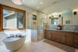 Experience luxury in this stunning bathroom featuring a freestanding soaking tub and a spacious glass-enclosed shower.