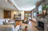 Experience luxurious living in this stunning great room, featuring a magnificent stone fireplace and expansive windows that offer breathtaking views.