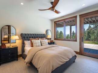 Experience serene living in this charming bedroom featuring a plush tufted headboard and a cozy waffle-knit duvet.