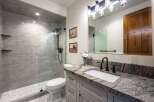 This modern bathroom features a spacious walk-in shower with subway tile and a sleek glass enclosure.