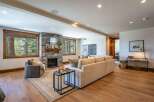 Experience luxurious living in this stunning mountain retreat, featuring a grand stone fireplace as the centerpiece of the spacious living area.