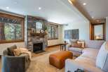 Experience cozy living in this inviting living room, featuring a striking stone fireplace as the focal point.