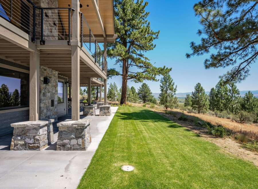 Experience luxury living with this stunning property featuring a multi-level deck and expansive lawn perfect for outdoor entertaining.