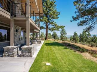 Experience luxury living with this stunning property featuring a multi-level deck and expansive lawn perfect for outdoor entertaining.