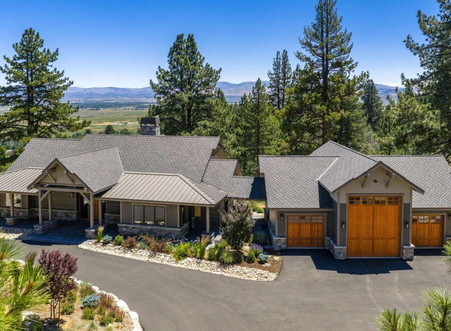 Experience luxury mountain living in this stunning custom-built home, nestled amidst towering pine trees with breathtaking valley views.