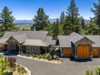 Experience luxury mountain living in this stunning custom-built home, nestled amidst towering pine trees with breathtaking valley views.