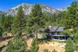 Nestled amidst towering pine trees and against a majestic mountain backdrop, this stunning home offers unparalleled natural beauty and luxurious living.