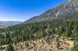 Nestled amidst a dense pine forest and rolling hills, this property offers a serene mountain retreat.