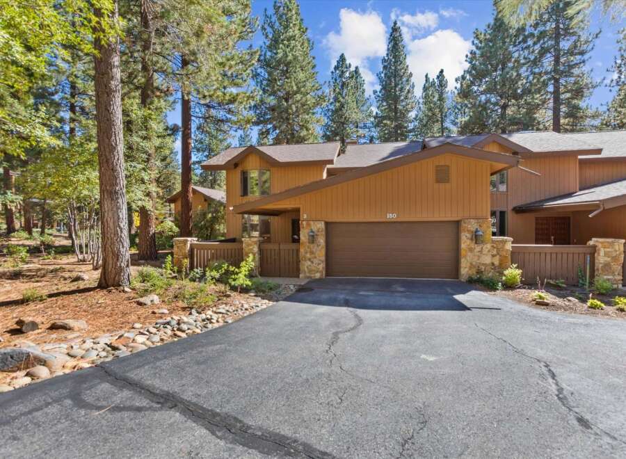 Nestled among tall pine trees, this charming property offers a serene mountain retreat.