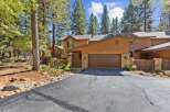 Nestled among tall pine trees, this charming property offers a serene mountain retreat.