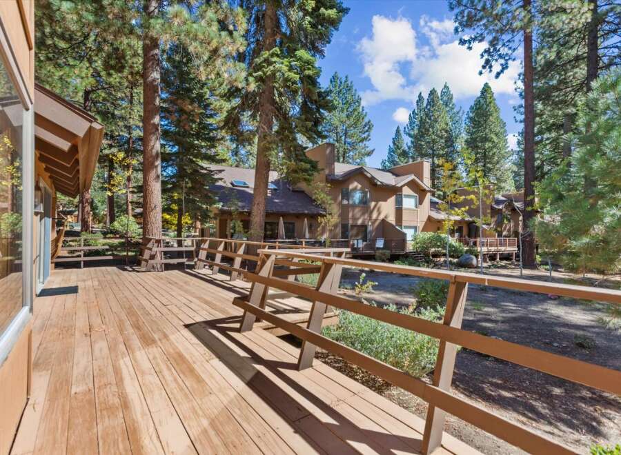Experience the serene mountain lifestyle with this stunning property featuring a spacious wooden deck perfect for outdoor entertaining.
