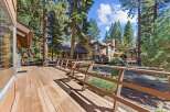 Experience the serene mountain lifestyle with this stunning property featuring a spacious wooden deck perfect for outdoor entertaining.