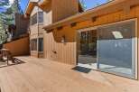 Enjoy the outdoors on this expansive wooden deck, perfect for entertaining or relaxing amidst the trees.