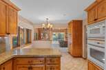 This spacious kitchen features beautiful natural wood cabinetry and a granite countertop, perfect for meal preparation and entertaining.