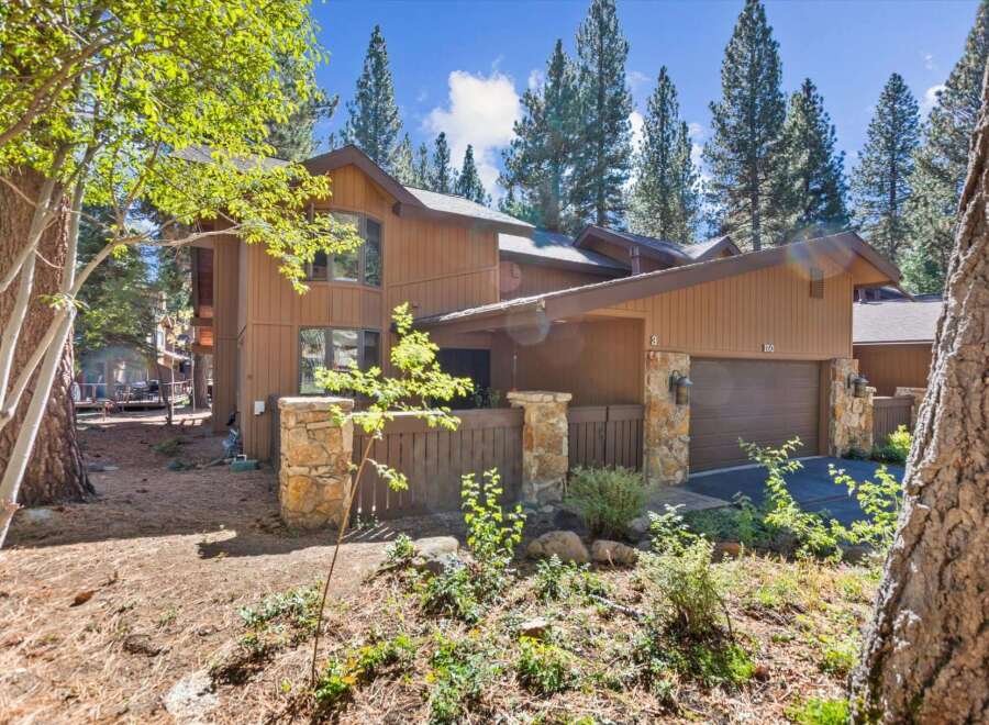Nestled amongst tall pine trees, this charming property offers a serene mountain retreat.