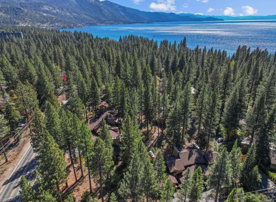 Nestled amidst a dense forest of towering pine trees, this property offers a serene retreat with stunning lake views.