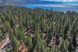 Nestled amidst a dense forest of towering pine trees, this property offers a serene retreat with stunning lake views.