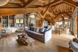 Experience rustic luxury in this stunning living space, featuring exposed wooden beams and a cozy, inviting atmosphere.