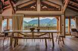 Experience breathtaking mountain views from this stunning chalet dining area.
