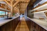 Experience luxury mountain living in this stunning kitchen, featuring rich dark wood cabinetry and elegant marble countertops.