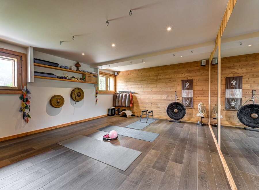 Discover this serene yoga and meditation studio, featuring a calming ambiance with natural wood accents and soft lighting.