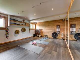 Discover this serene yoga and meditation studio, featuring a calming ambiance with natural wood accents and soft lighting.