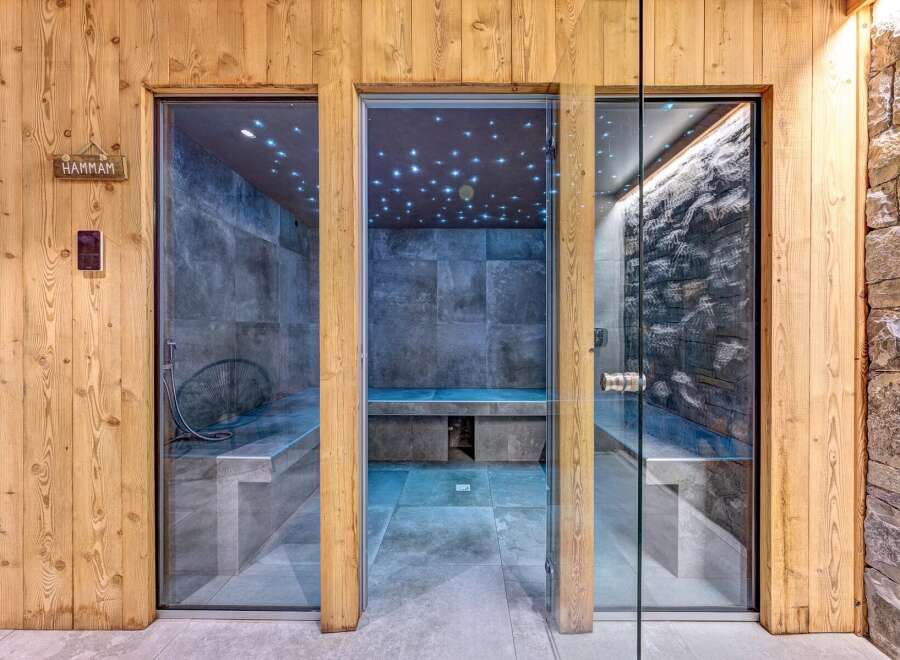 Experience ultimate relaxation in this luxurious spa area, featuring a modern hammam and a stone-clad sauna.