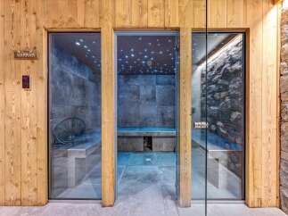 Experience ultimate relaxation in this luxurious spa area, featuring a modern hammam and a stone-clad sauna.