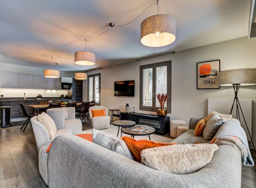 Experience modern living in this spacious open-plan apartment, featuring a sleek kitchen with integrated appliances and a comfortable dining area.