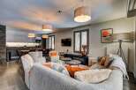 Experience modern living in this spacious open-plan apartment, featuring a sleek kitchen with integrated appliances and a comfortable dining area.