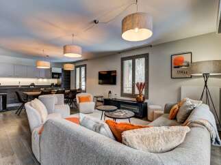Experience modern living in this spacious open-plan apartment, featuring a sleek kitchen with integrated appliances and a comfortable dining area.