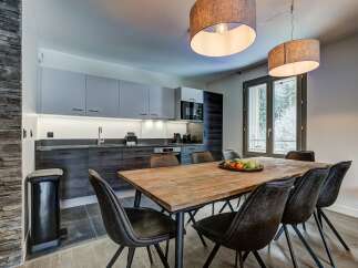Experience modern living in this stylish dining area, featuring a rustic wooden table perfect for family gatherings.