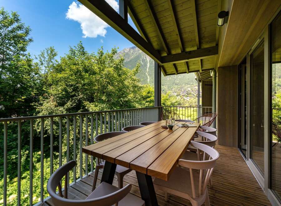 Enjoy breathtaking mountain views from this stunning balcony, perfect for al fresco dining.