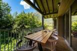 Enjoy breathtaking mountain views from this stunning balcony, perfect for al fresco dining.