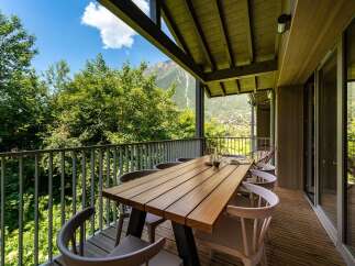 Enjoy breathtaking mountain views from this stunning balcony, perfect for al fresco dining.