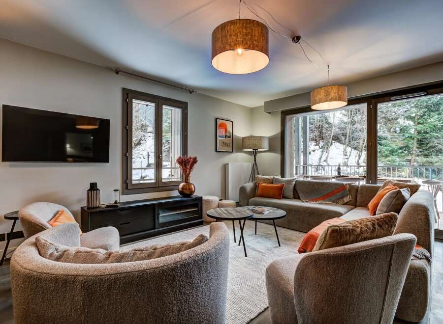 Experience cozy living in this beautifully appointed living room, featuring a plush sectional sofa perfect for relaxation.