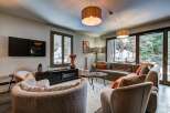 Experience cozy living in this beautifully appointed living room, featuring a plush sectional sofa perfect for relaxation.