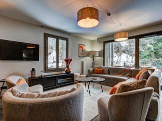 Experience cozy living in this beautifully appointed living room, featuring a plush sectional sofa perfect for relaxation.