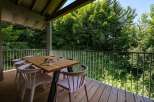 Enjoy al fresco dining on this spacious wooden deck, complete with a modern table and chairs.