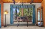 Experience breathtaking mountain views from this charming room, featuring a classic wooden desk and a beautiful glass display cabinet.