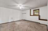 This room features a textured ceiling with a white ceiling fan, perfect for air circulation.